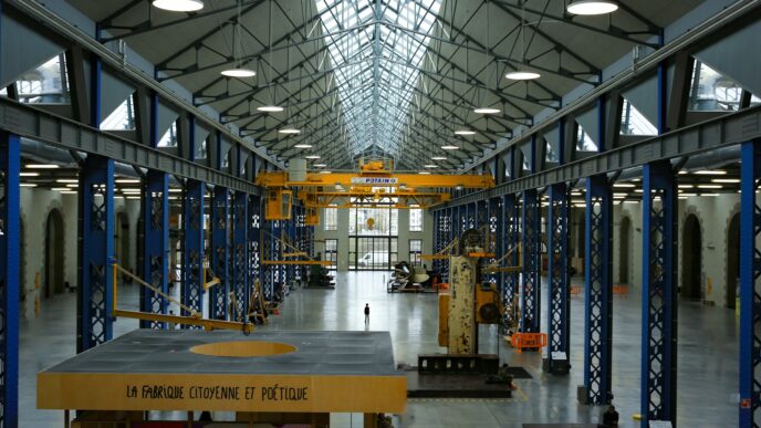 An industrial hall with machinery and high ceilings.