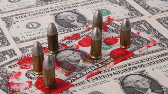 a pile of money with bullet shells on top of it